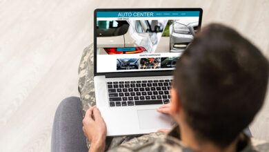 Person in chair buying car on laptop