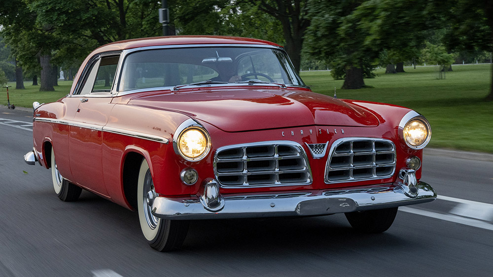 Red 1955 Chrysler 300 driving on road