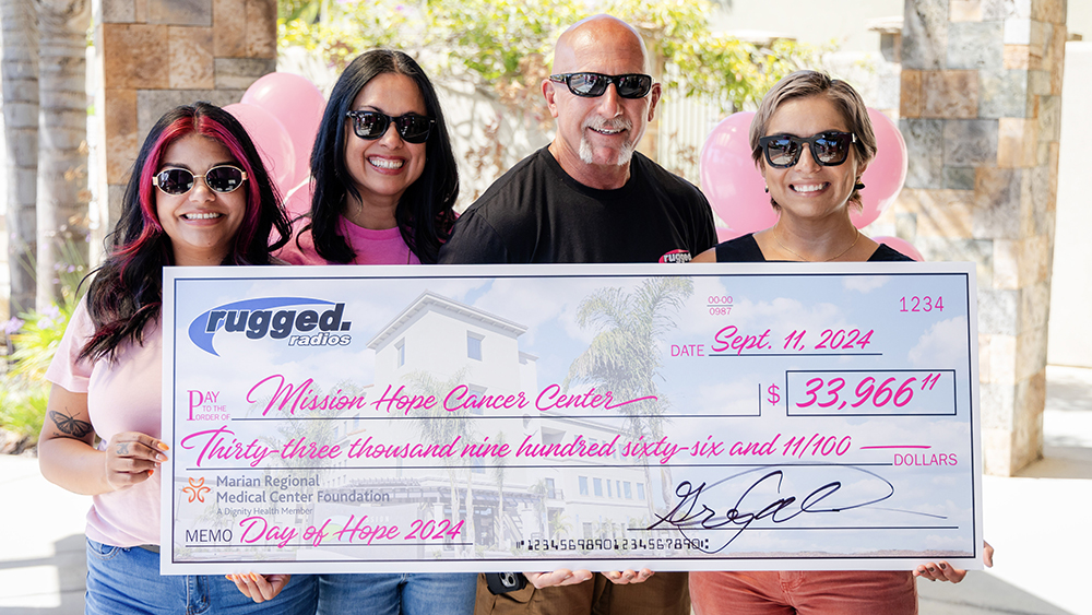 Rugged Radios employees holding Mission Hope Check 2024