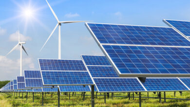 solar panels and wind turbines generating electricity in power