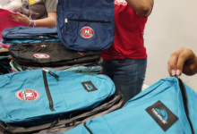 Stack of backpacks at RNR Tires Express giveaway
