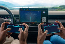 Two people using smartphones to play Breakout Recharged in a Volkswagen through AirConsole