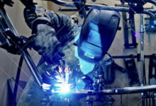 Welder with full mask and sparks