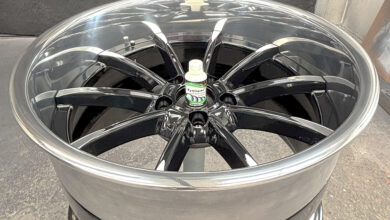 Aluminum wheel on floor with bottle sitting in center