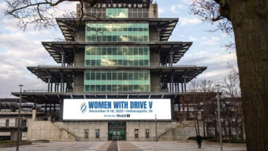 Women with Drive banner on front of building