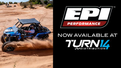 ATV driving through sand, EPI and Turn 14 Distribution logos