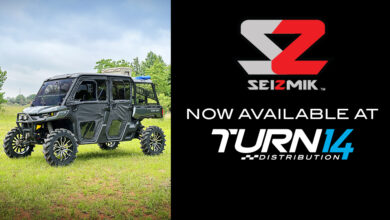 UTV parked in grass with Seizmik and Turn 14 Distribution logos