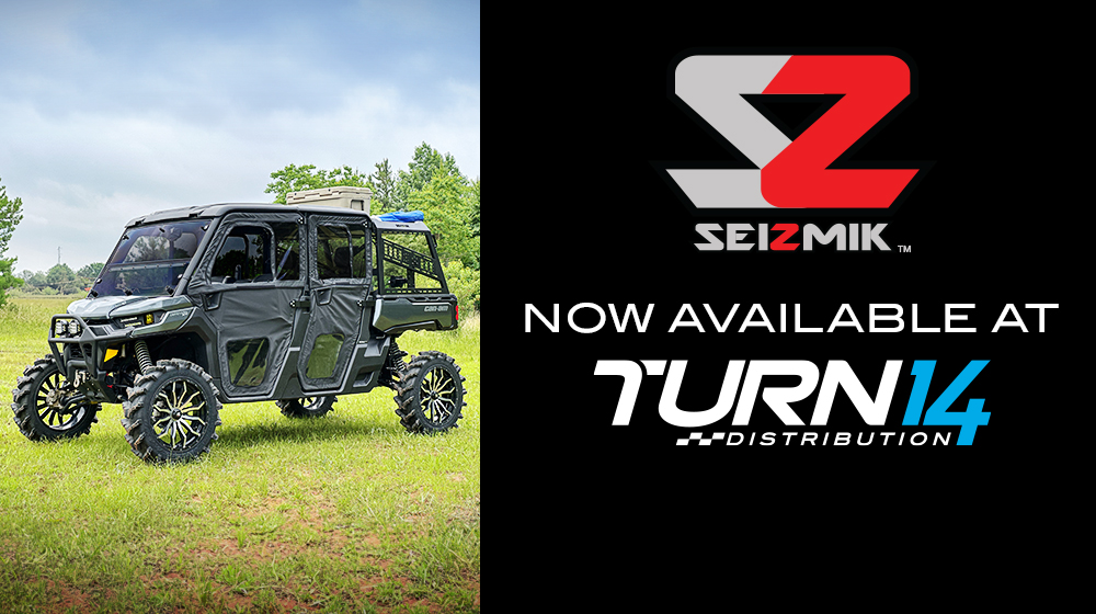 UTV parked in grass with Seizmik and Turn 14 Distribution logos