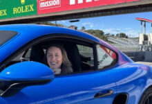 April Henderson sitting in car at racetrack cropped