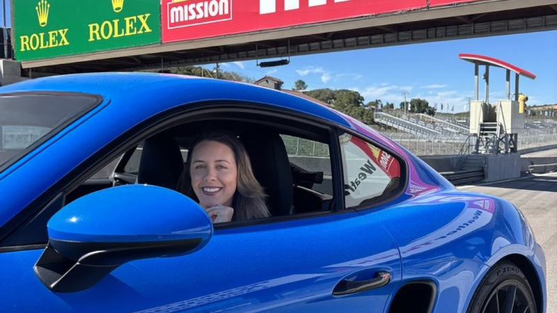 April Henderson sitting in car at racetrack cropped