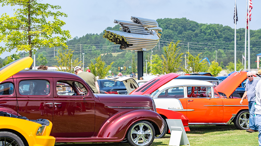 Classic cars with open hoods on the Savoy Automobile Museum grounds