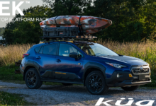 Kuat DEK Rooftop Platform mounted to Subaru Crosstrek with Kayak parked near lake