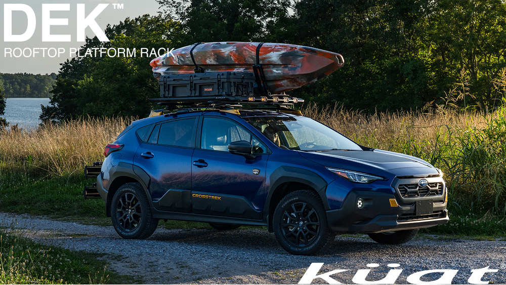 Kuat DEK Rooftop Platform mounted to Subaru Crosstrek with Kayak parked near lake