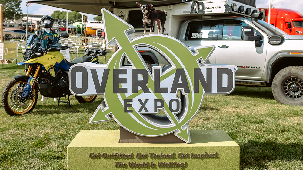 Overland Expo sign in front of truck camper