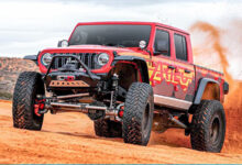Jeep kicking up sand in the desert