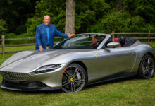 John Davis of MotorWeek standing next to Ferrari Roma