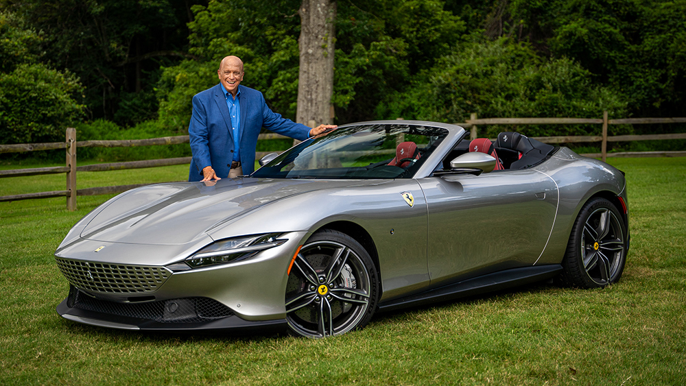 John Davis of MotorWeek standing next to Ferrari Roma