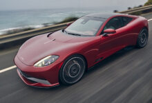 2027 Karma Amaris GT Coupé driving on road next to ocean