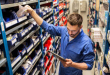 auto mechanic or smith with tablet pc at workshop
