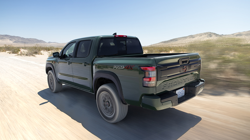 Nissan Pro-4X R from rear driving on dirt road