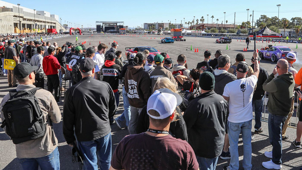Optima Unleashed at the SEMA Show with crowd watching car displays