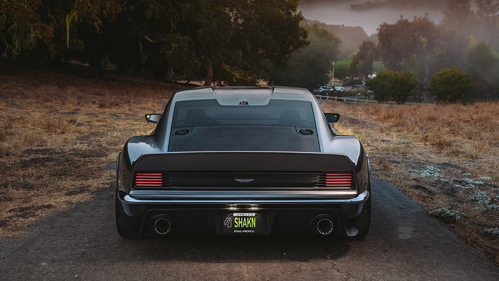 Ringbrothers OCTAVIA 805-Horsepower 1971 Aston Martin DBS driving away on country road