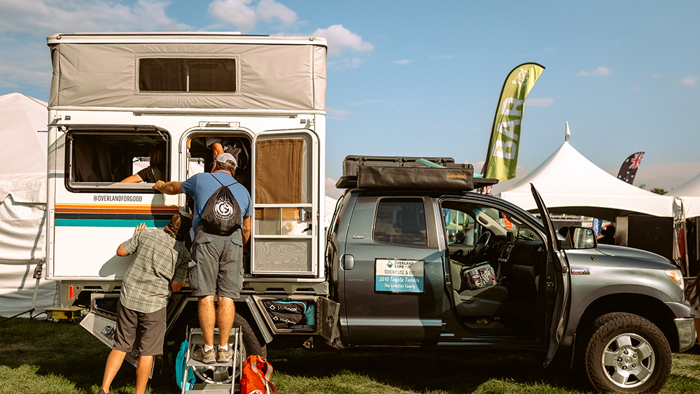 People looking at camper at Overland Expo Mountain West