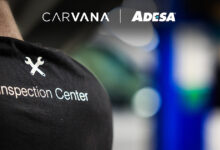 Back of persons T-shirt with Carvana ADESA Inspection Center logo