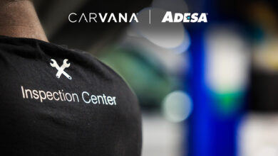 Back of persons T-shirt with Carvana ADESA Inspection Center logo