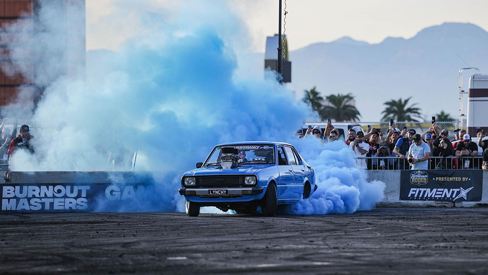 Car doing burnout with blue smoke