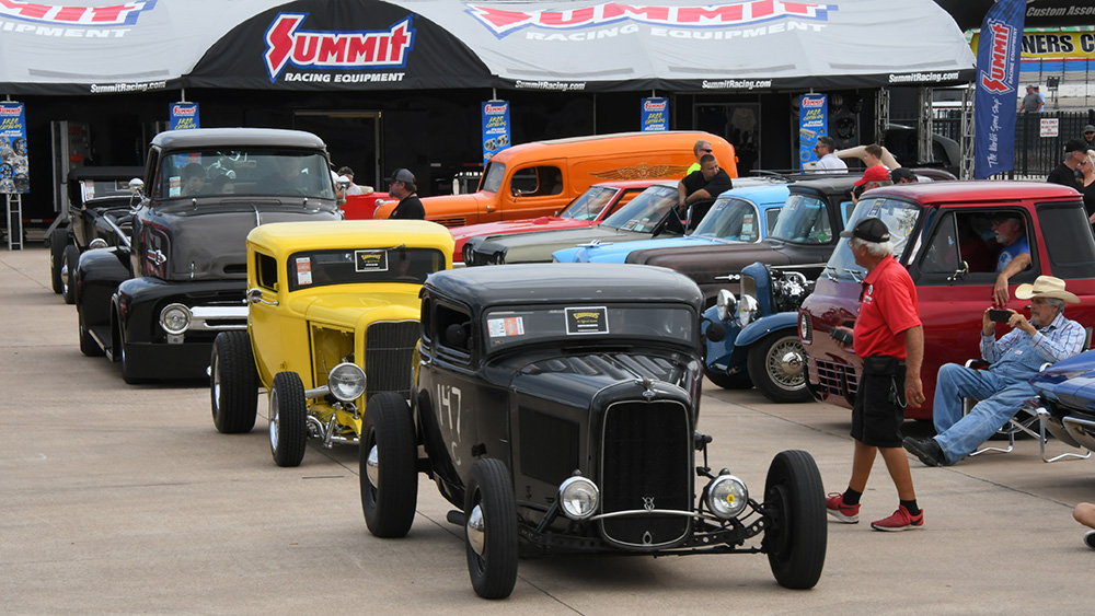 Classic cars driving in a line at Goodguys Lone Star Nationals