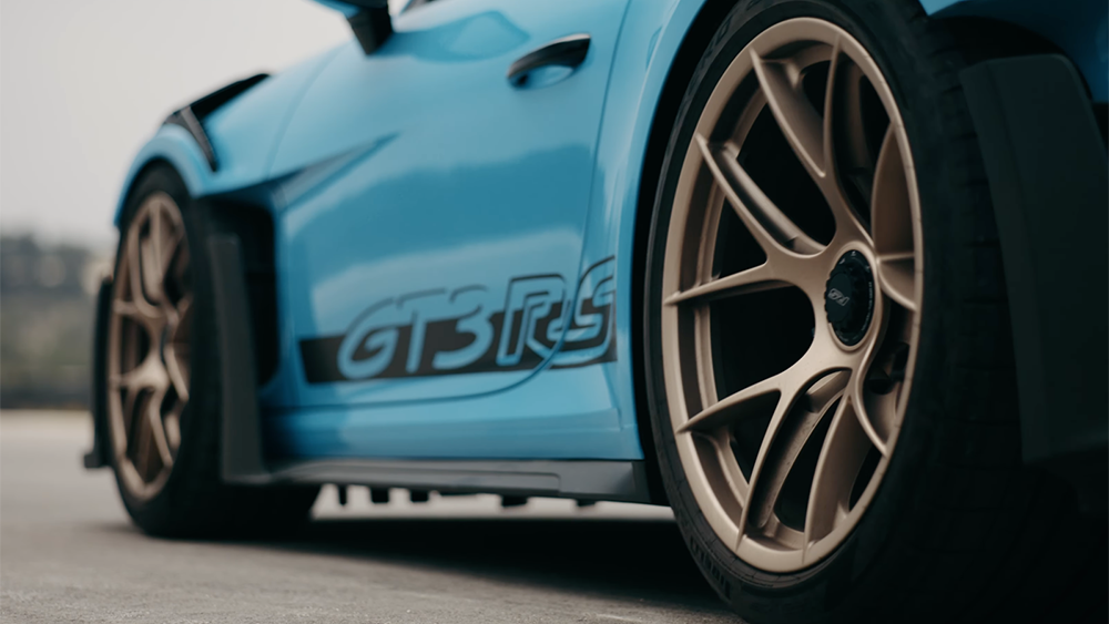 Down low close-up of Porsche 911 GT3 RS with blue film by XPEL