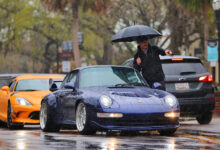 Person directing cars where to park during storm