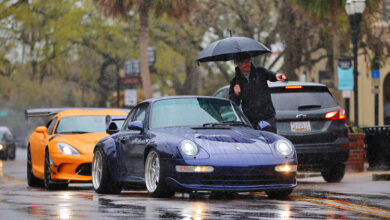 Person directing cars where to park during storm