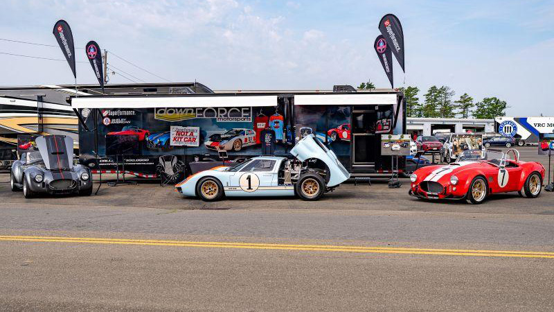 Historic race cars in front of Downforce Motorsports trailer copy
