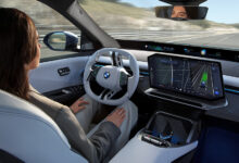 Person in drivers seat using Snapdragon Ride Pilot in BMW iX3