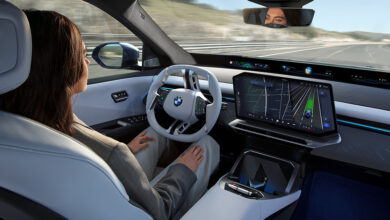 Person in drivers seat using Snapdragon Ride Pilot in BMW iX3