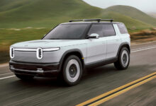 Rivian R2 SUV driving on road by Eric Anderson