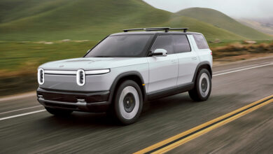 Rivian R2 SUV driving on road by Eric Anderson