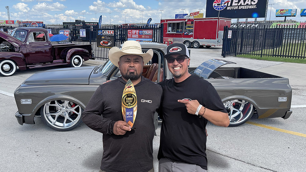 Ruben Terraza holding trophy in front of his custom 1968 C10