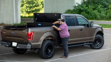 toolbox cargo man reaches into truck bed-mounted toolbox from lippert