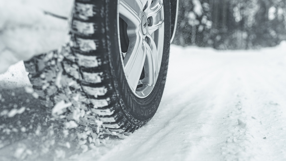 Closeup of tire driving through snow