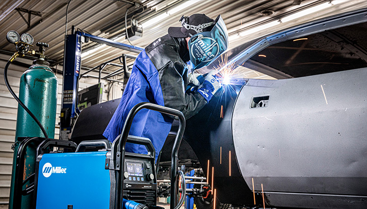 Person using Millermatic 211 PRO for welding application