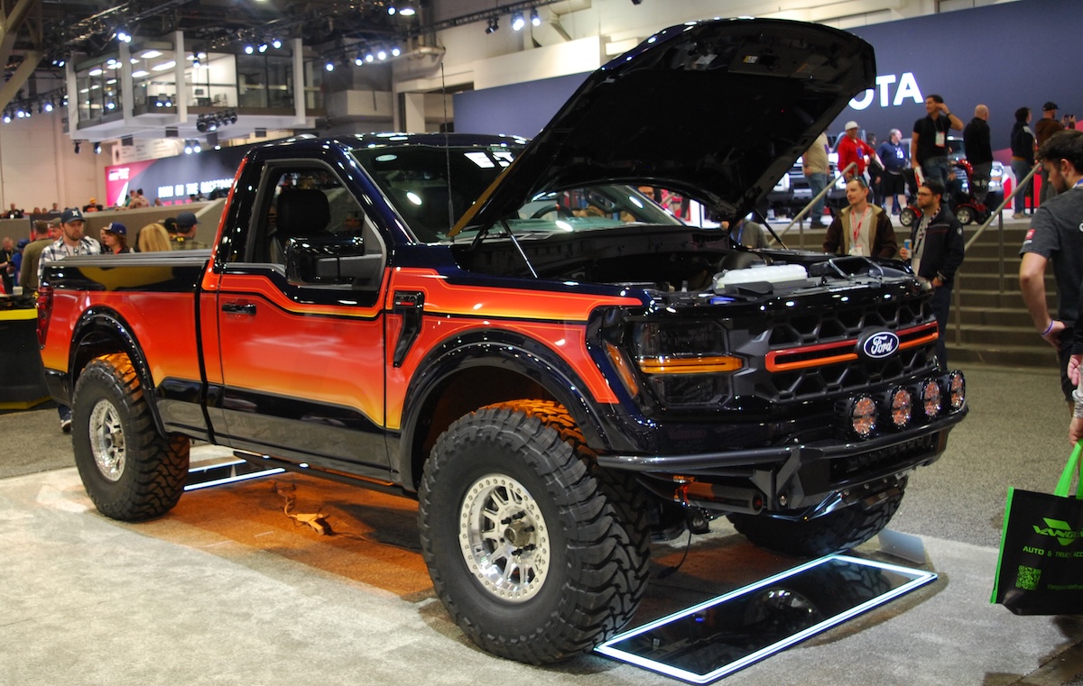 sema show 2025 lifted black, orange and red Ford lifted pickup in central hall