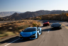 Three Lamborghinis driving on road