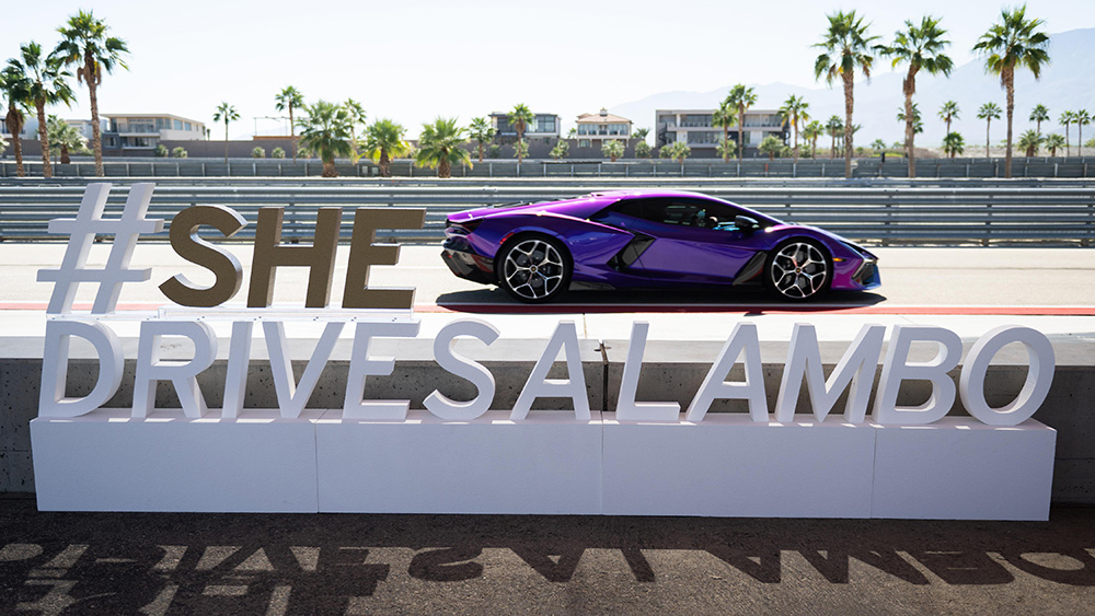 SHEdrives a Lambo sign and car