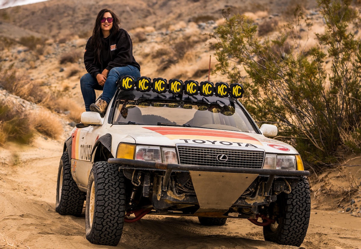 automotive influencers natasha adams sits on truck on trail