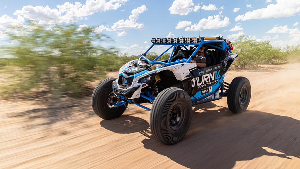 Turn 14 Distribution x Bilstein 2025 Can-Am Maverick X3 on dirt road