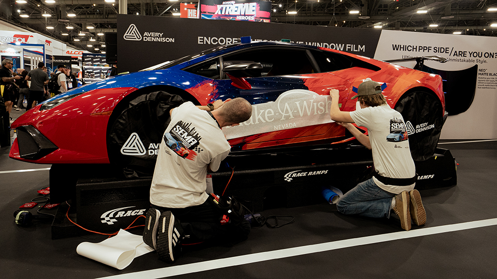 Avery Dennison - SEMA MAW Nevada (L-R) Wish Teens Jakob Altenberger and Cameron Enge work on adding the Make A Wish Logo to brand the Lamborghini