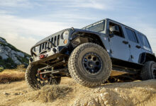 Jeep driving over rocks